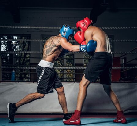 Two sportive men have a boxing competition on the ring